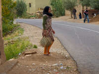girls cleaning street Ait Arbi, Dades Valley, Morocco, Africa